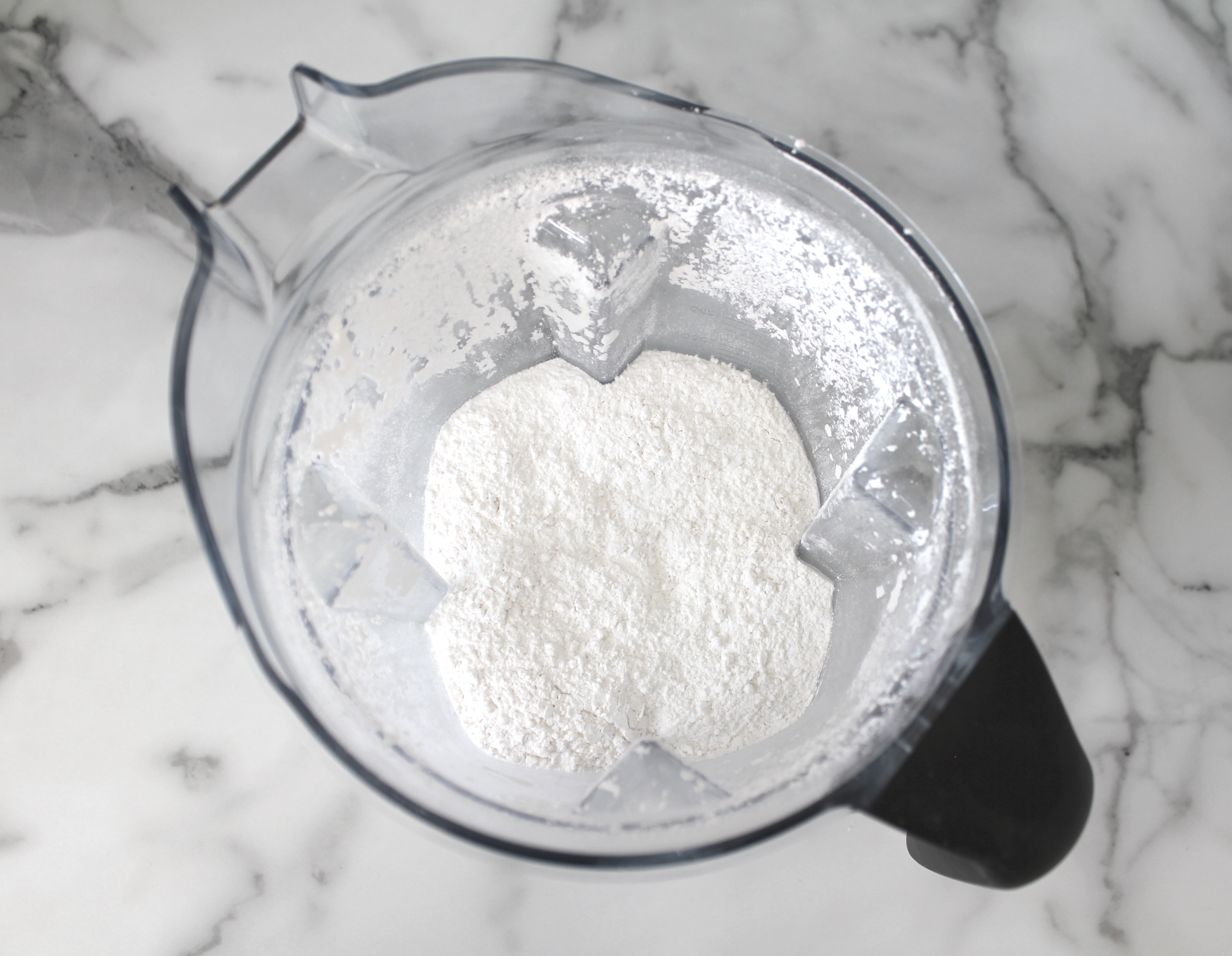 Vitamix blender with vegan icing sugar.