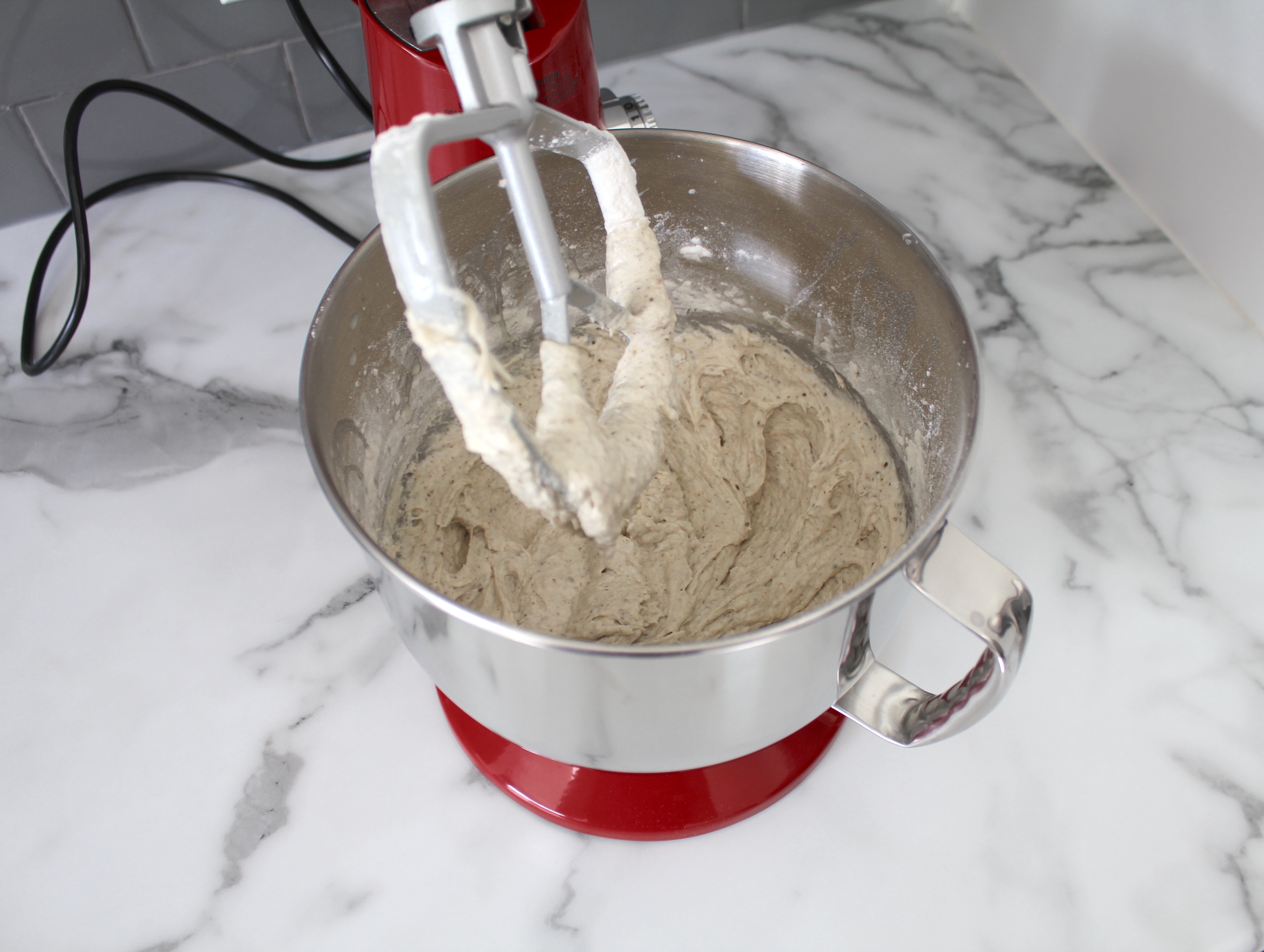 Stand mixer with mixed vanilla cake batter.